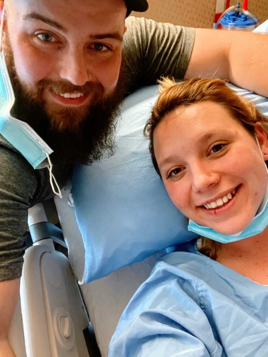 Couple take a selfie with the woman is getting an ultrasound at the doctor's