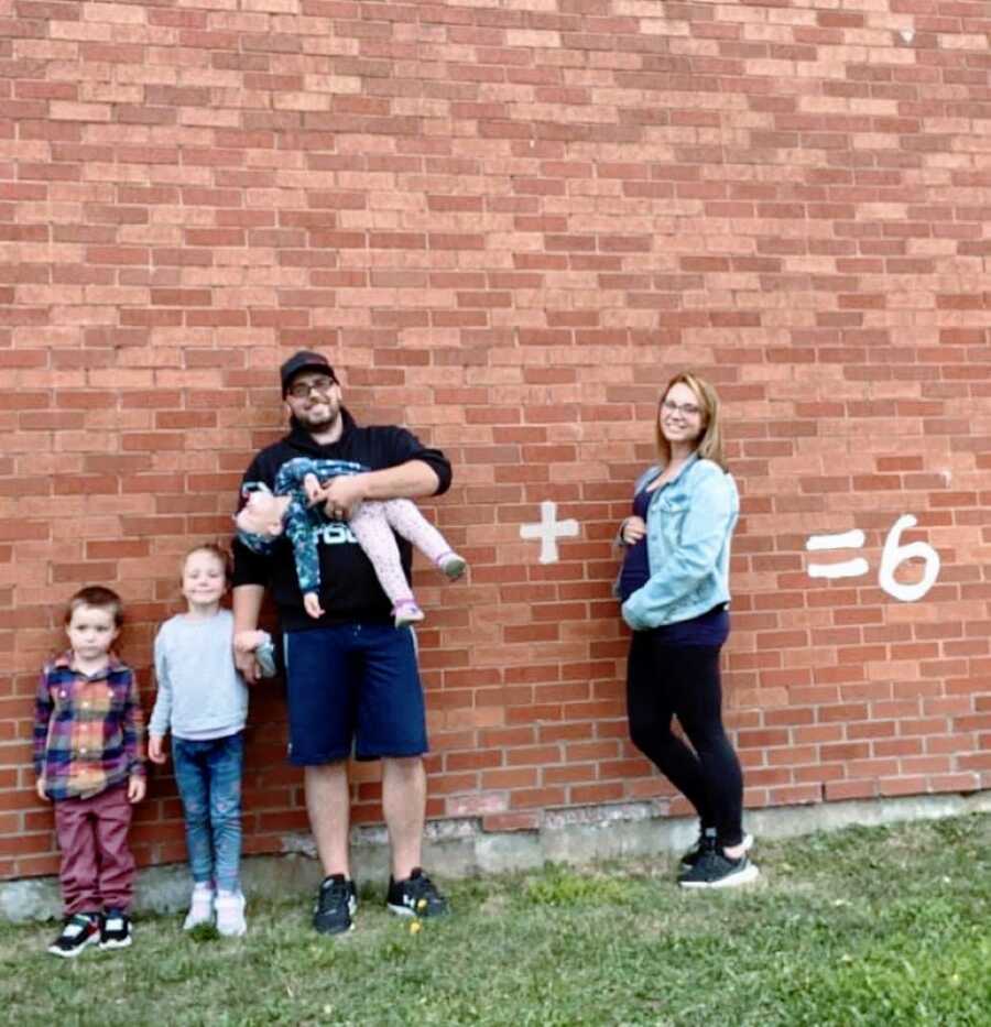 Woman announces fourth pregnancy with her husband and three kids with a photoshoot