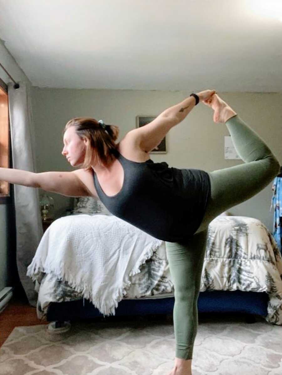 Pregnant woman practice yoga in her bedroom to help calm her emotions