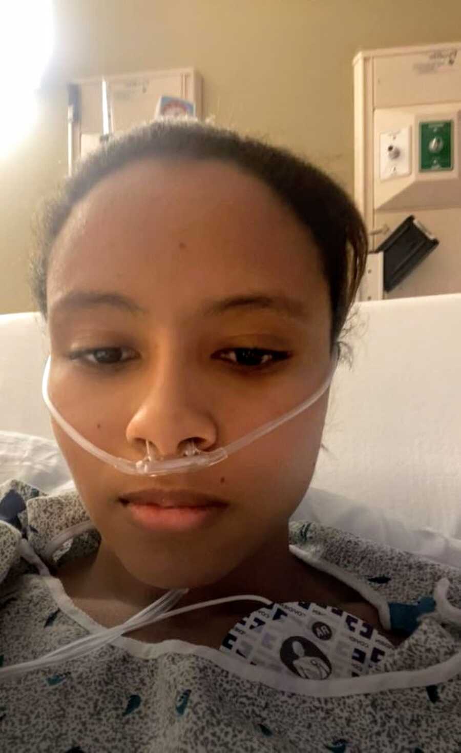 Woman fighting heart failure and multiple heart attacks takes a selfie in a hospital bed while hooked to oxygen