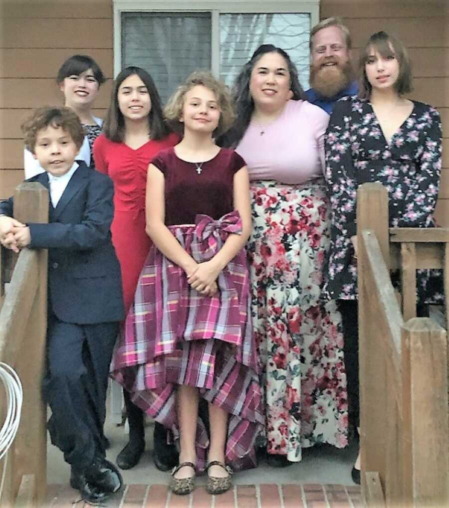 Mixed family Asian-American family standing on a porch