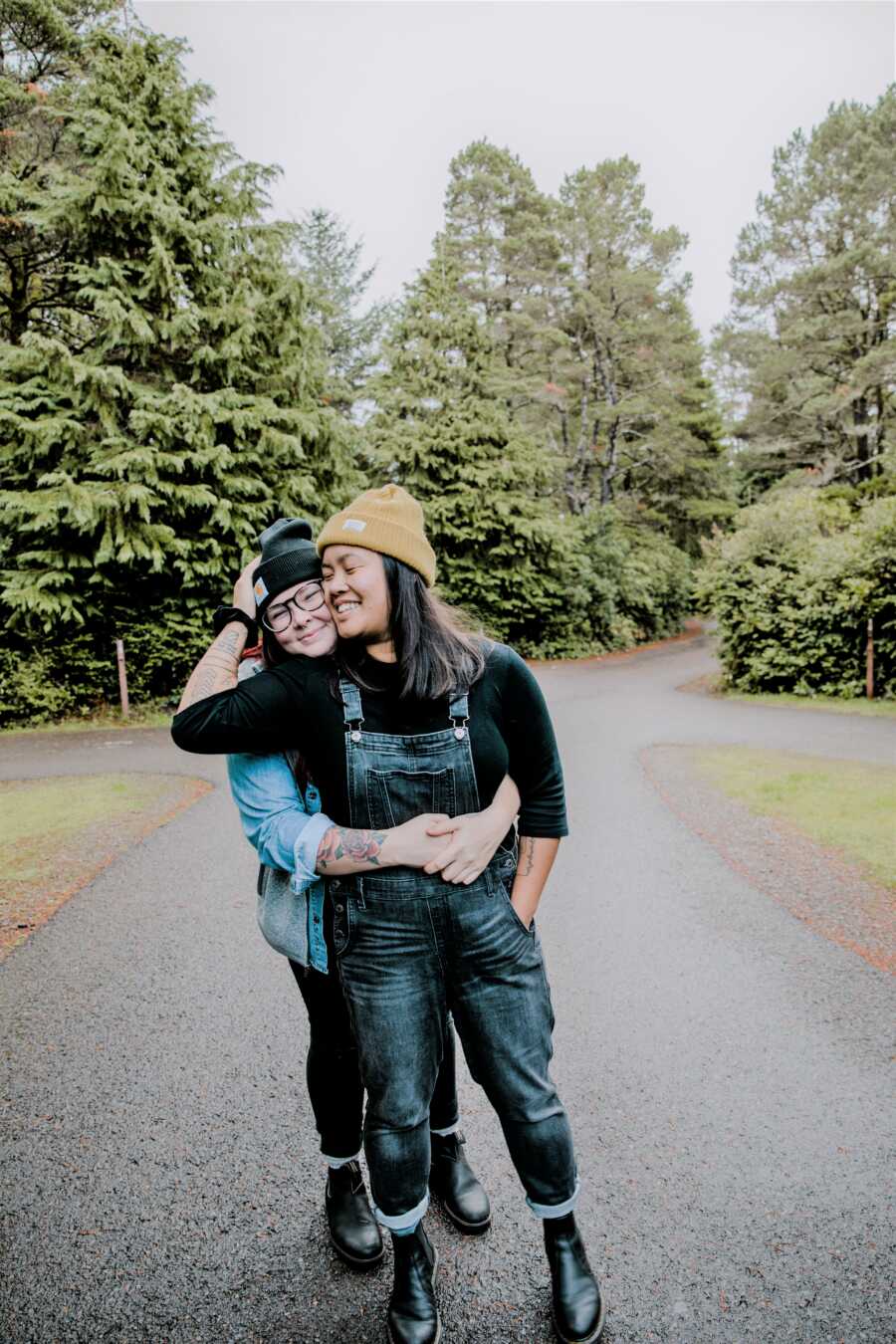 LGBT van life couple take sweet photo during a photoshoot out in the woods