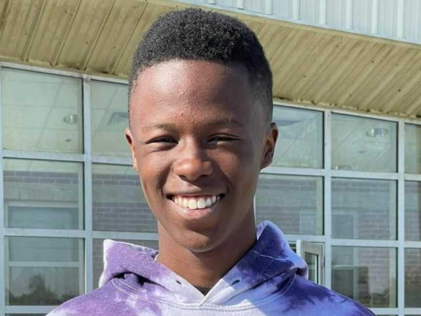 son with his driver's license smiling at the camera