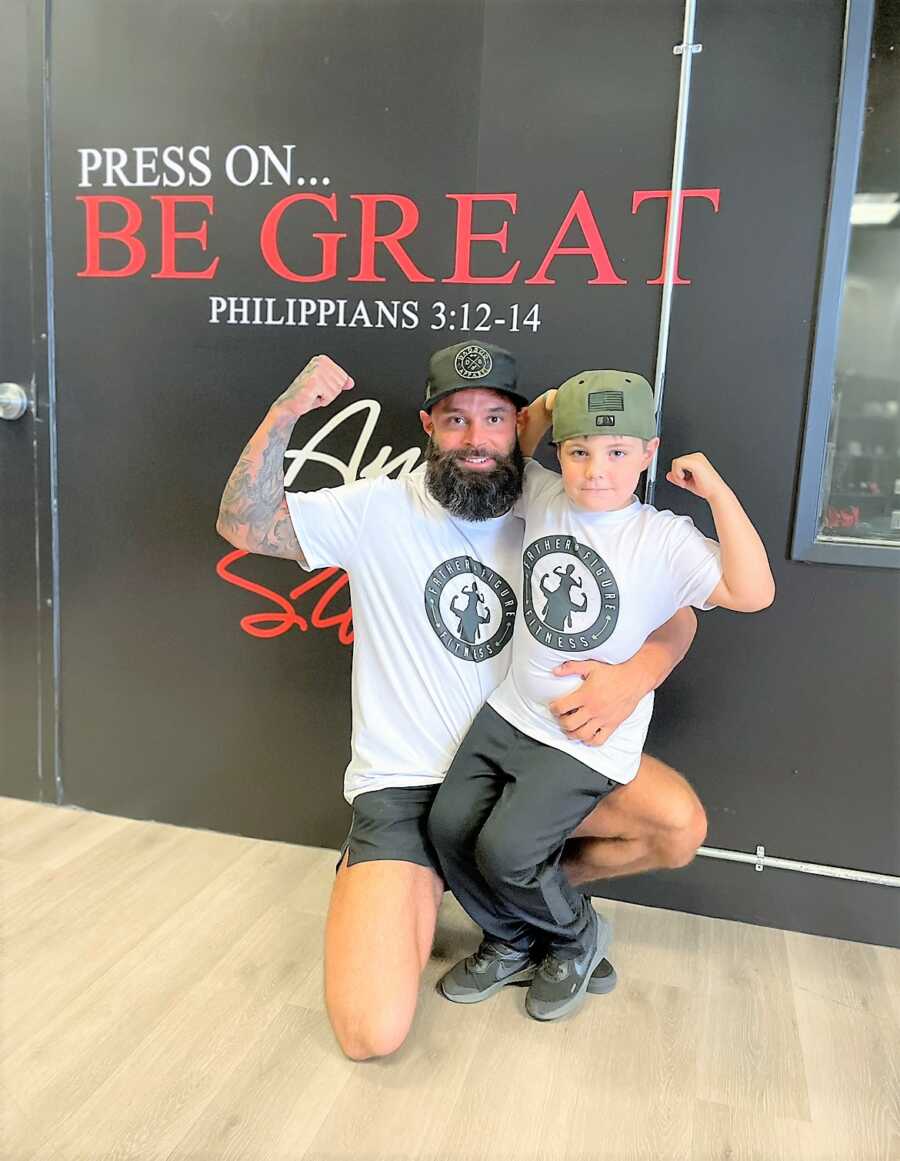 father and son flexing their arms wearing matching shirts