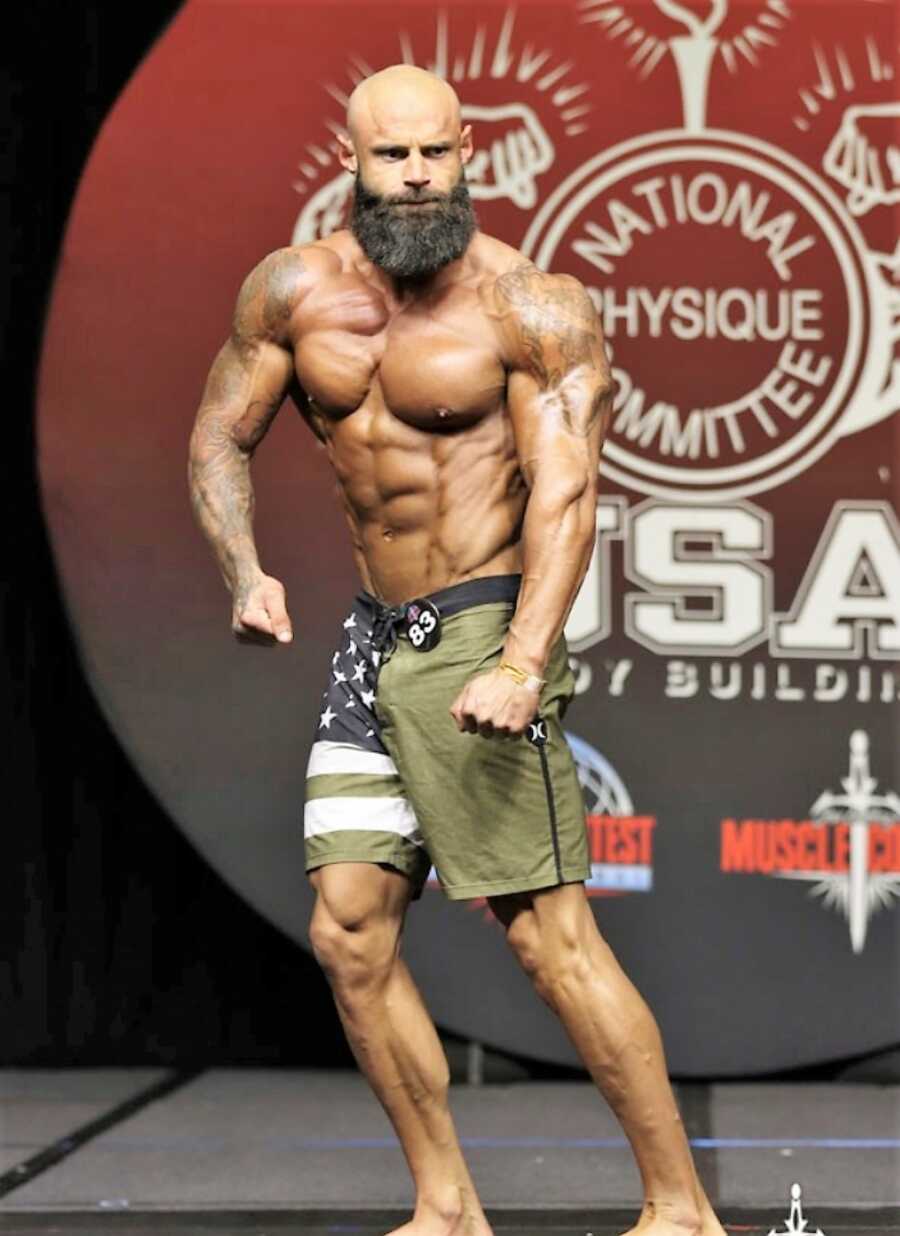 bodybuilder waling on stage during a competition