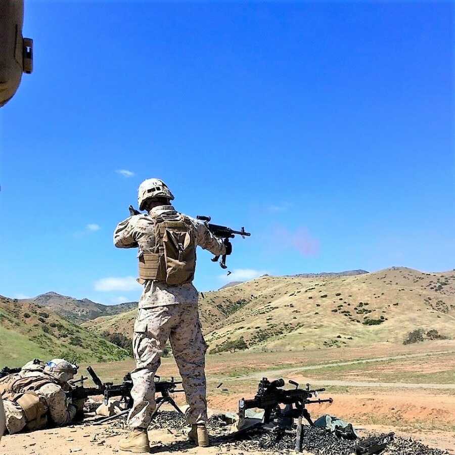 Marine Corp officer wearing combat gear and aiming his