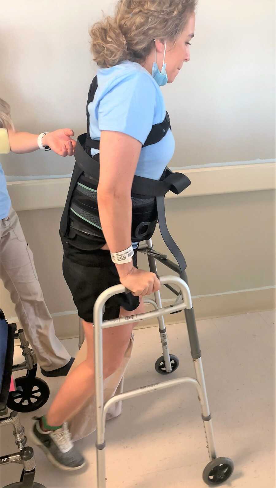 Young woman walking with crutches at the hospital while recovering from skydiving accident 