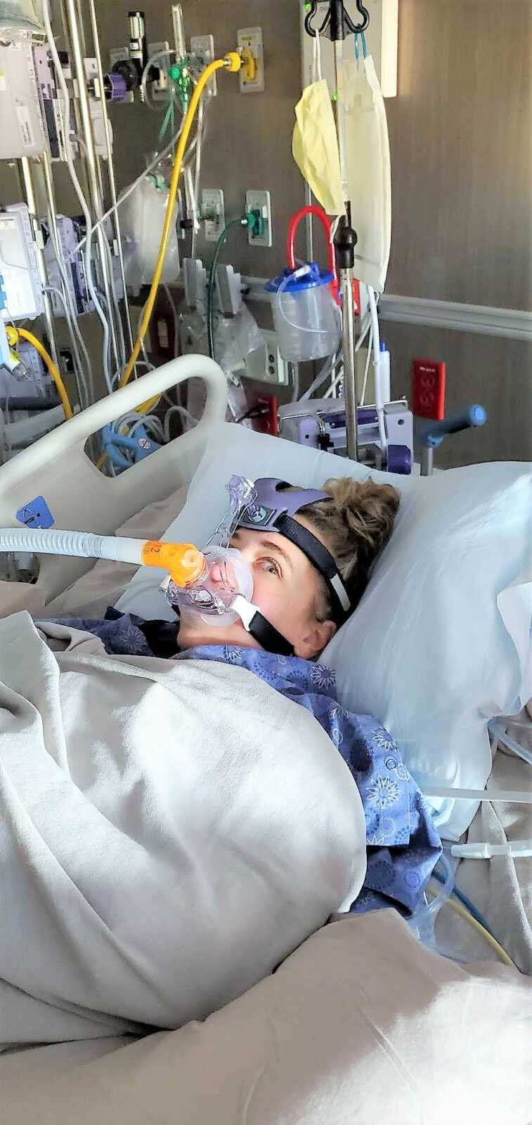 woman with multiple broken bones laying at a hospital bed with oxygen tube attached to her face after skydiving accident 