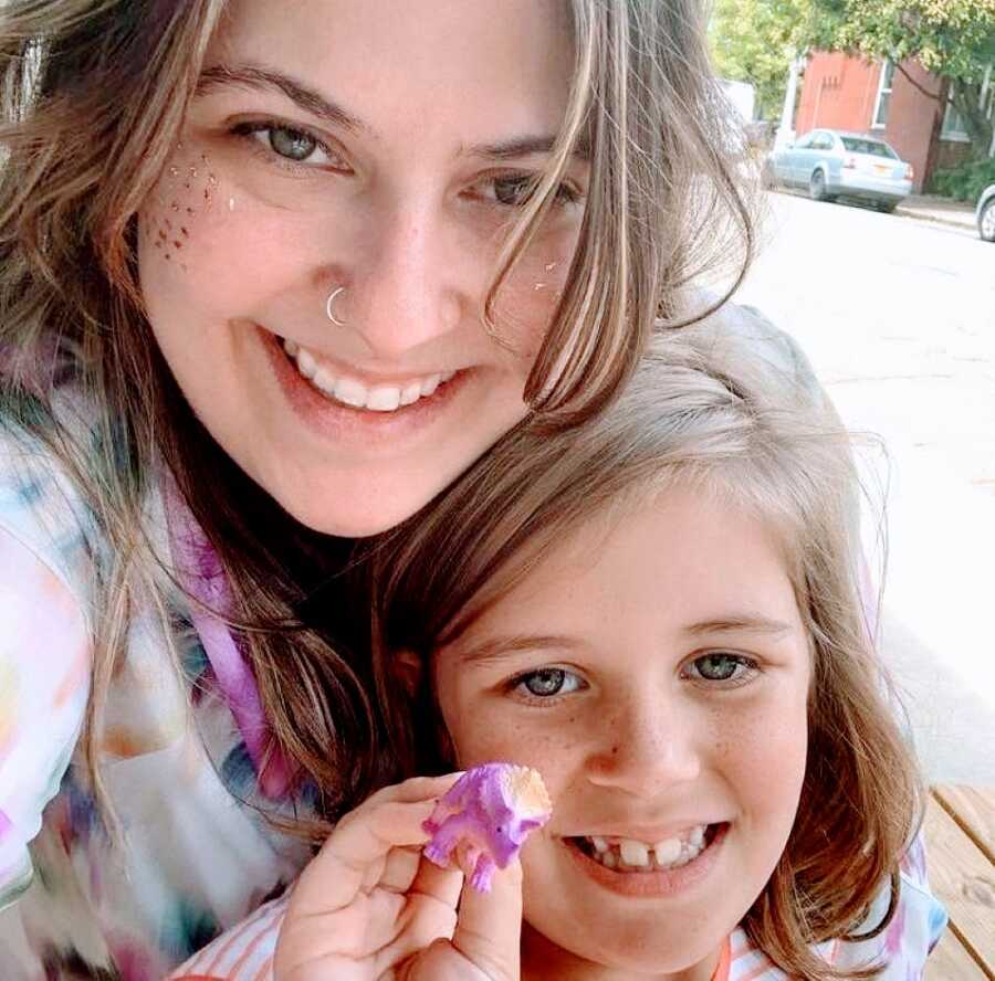 Birth mom and daughter take a selfie together during an outdoor visit together