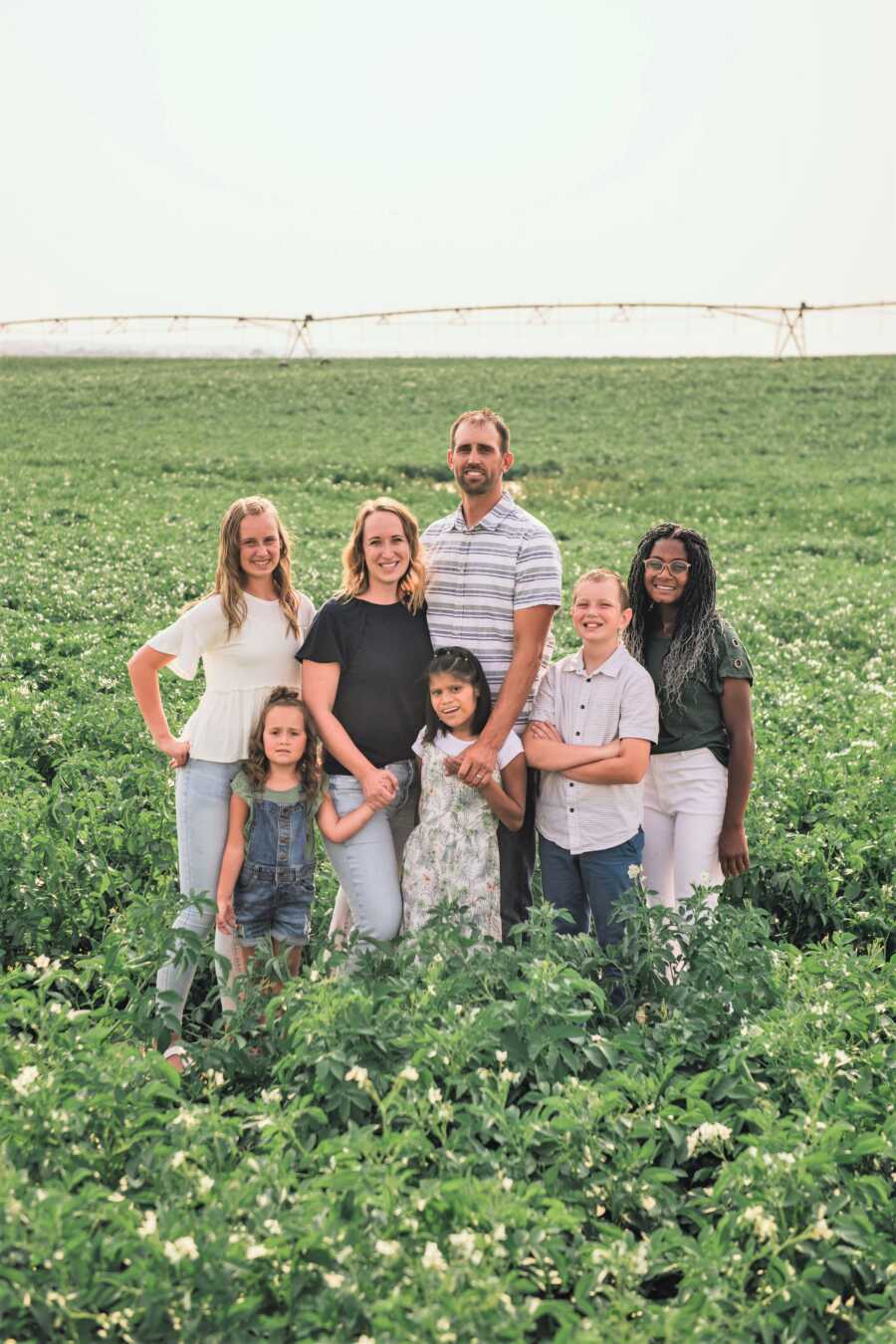 Outdoor family portrait om and dad with their 5 kids, three biological and 2 adopted