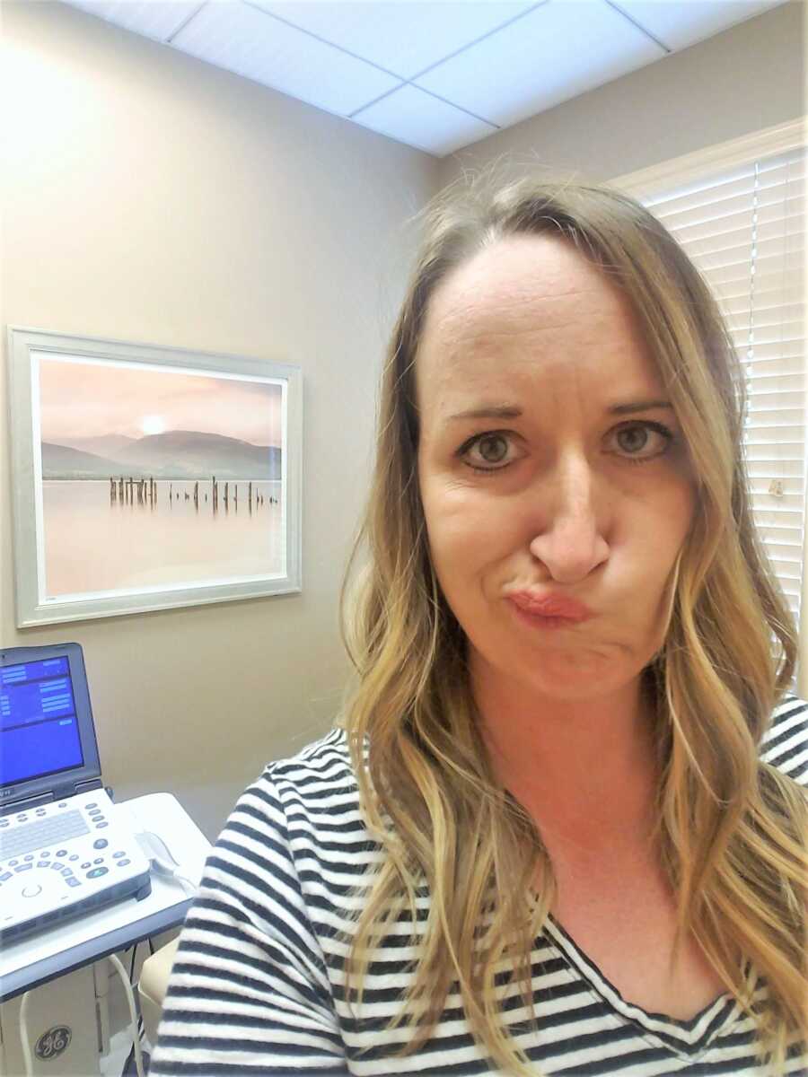 Selfie of woman making a funny face while at the doctor 