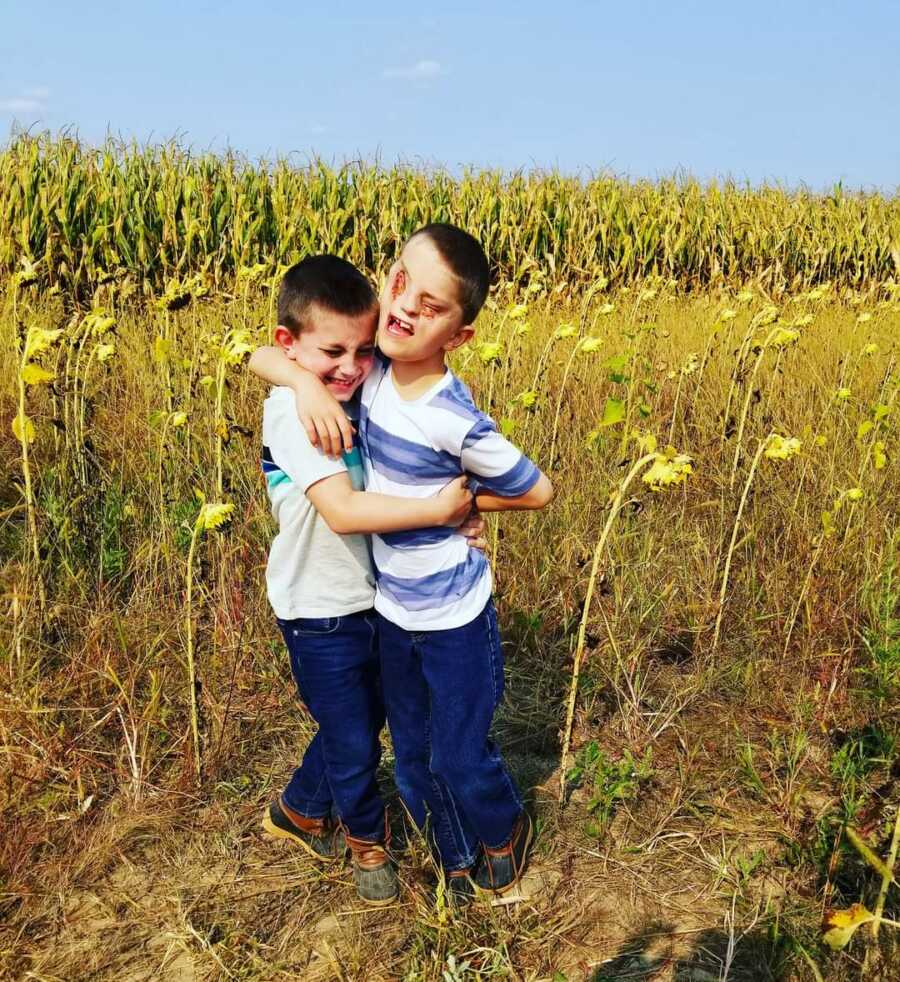 two brothers hugging each other close