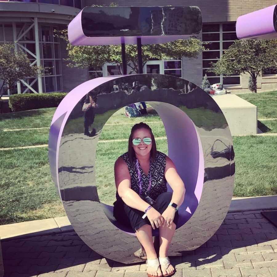 mom sitting in a sculpture 