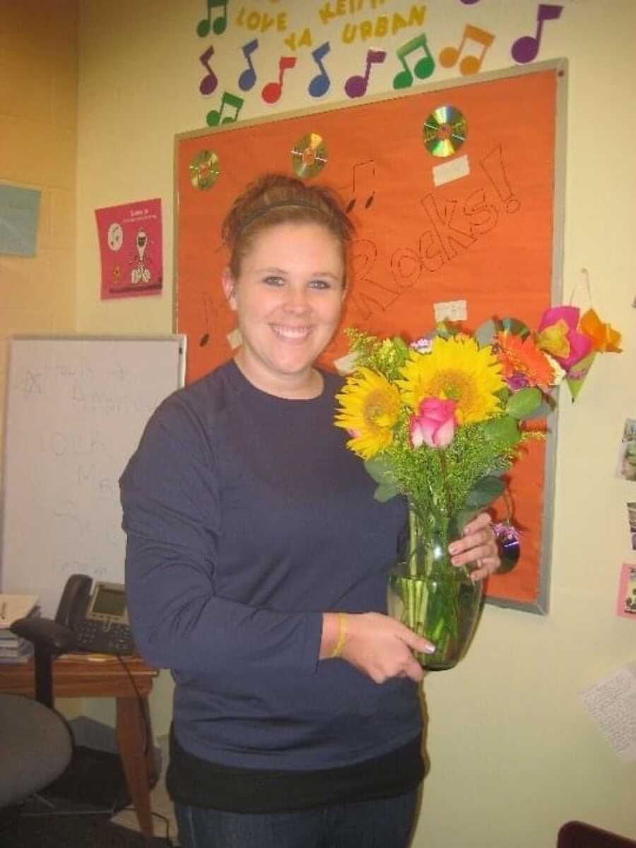 woman with flowers smiling