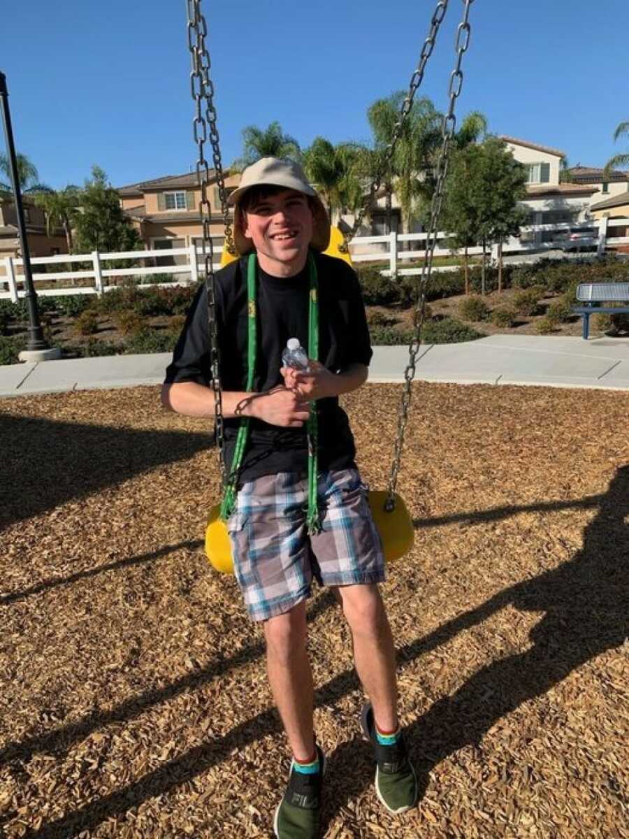 son with autism on the swing