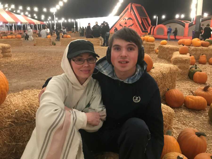 woman and her son at a pumpkin patch