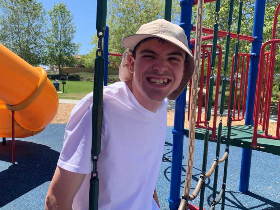 son at the play ground smiling