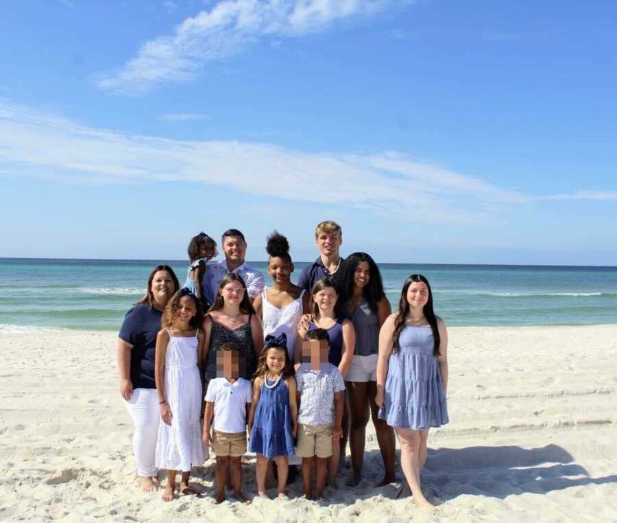 Foster, adoptive family take a family photo on the beach with their 10 kids