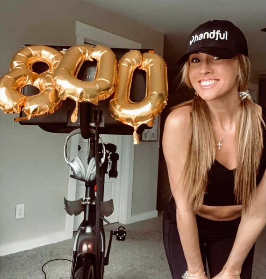 Woman on sobriety journey celebrates her 800th Peloton ride with gold balloons