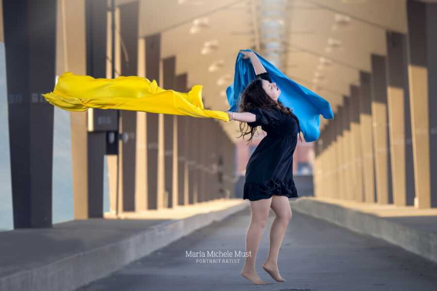 woman with the ukraine colors flying around