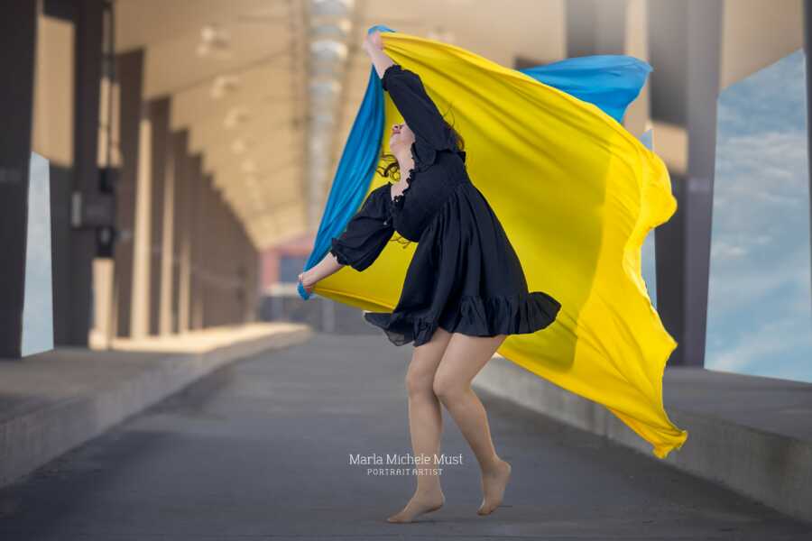 woman with ukraine colors bending to one side