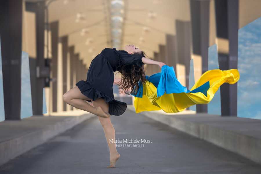 woman with ukraine colors standing on one leg