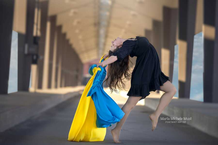 woman with ukraine colors jumping up 