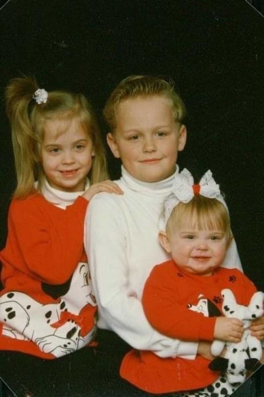 three siblings posing together for a picture