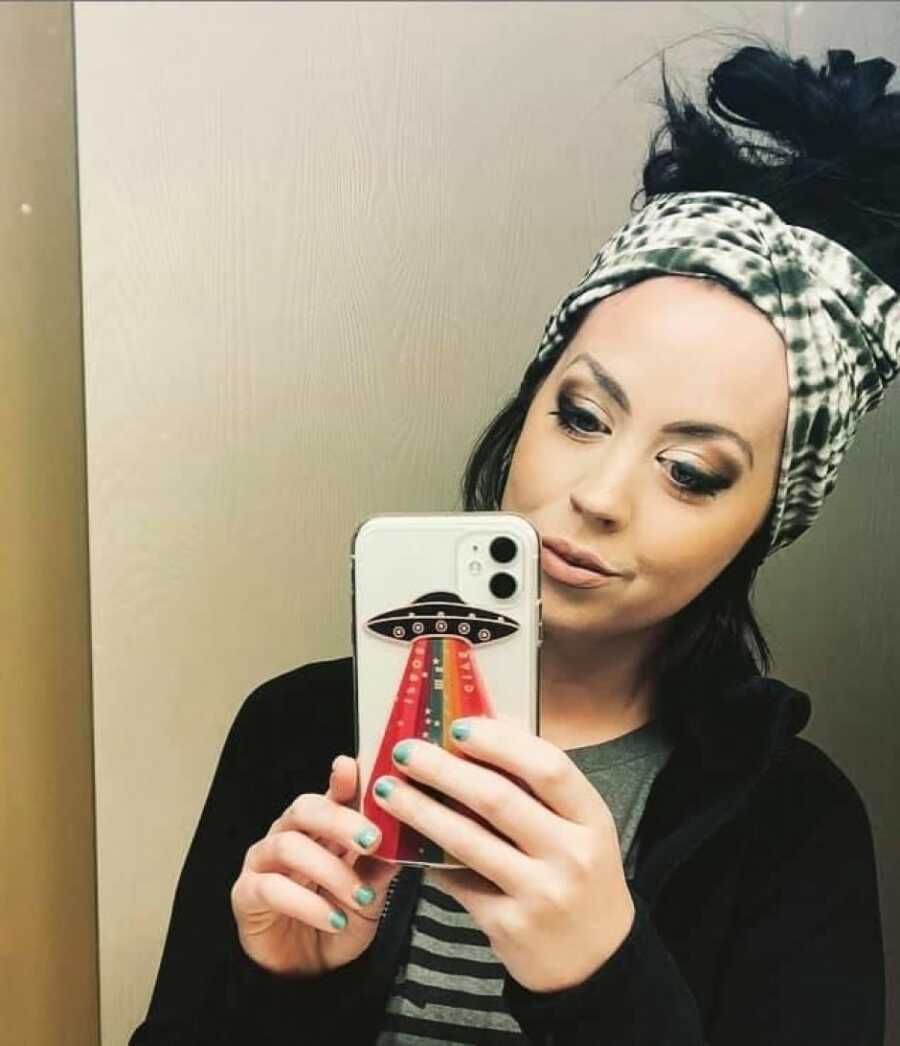 woman taking a selfie in the mirror