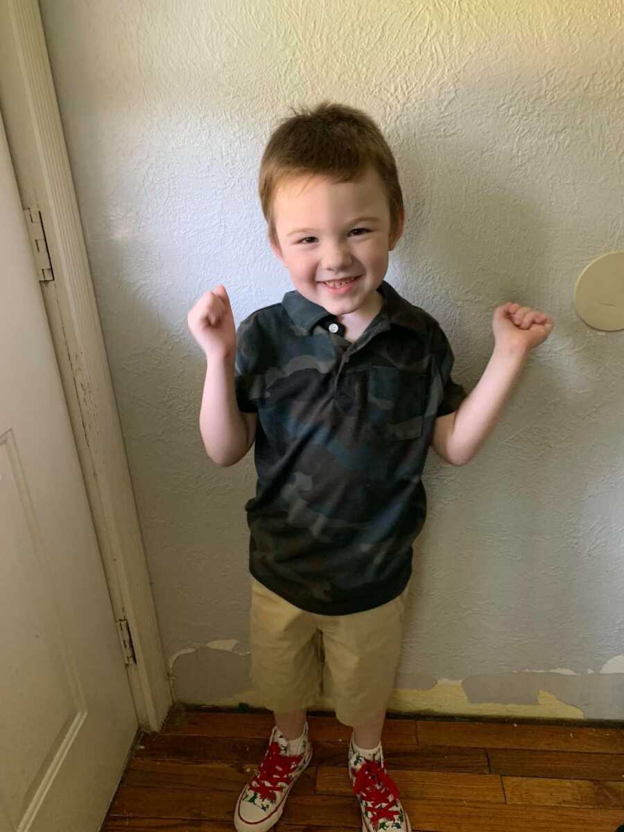 boy smiling by the door