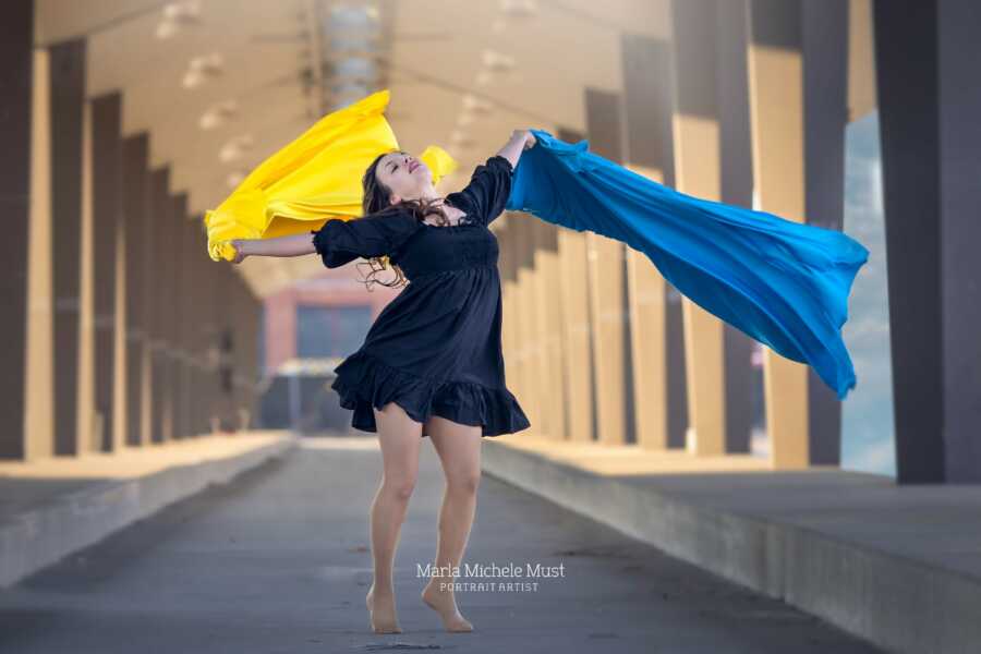 woman dancing with ukraine colors