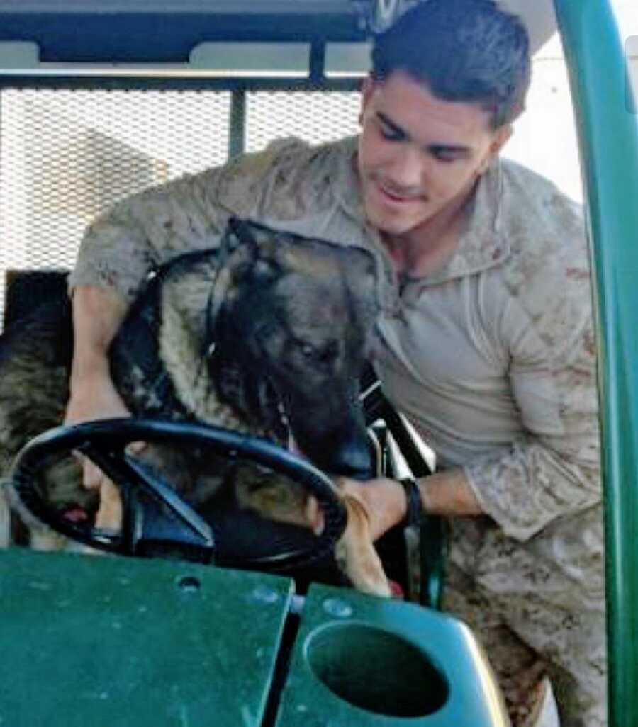 Young Marine helps his K-9 partner out of a golf cart