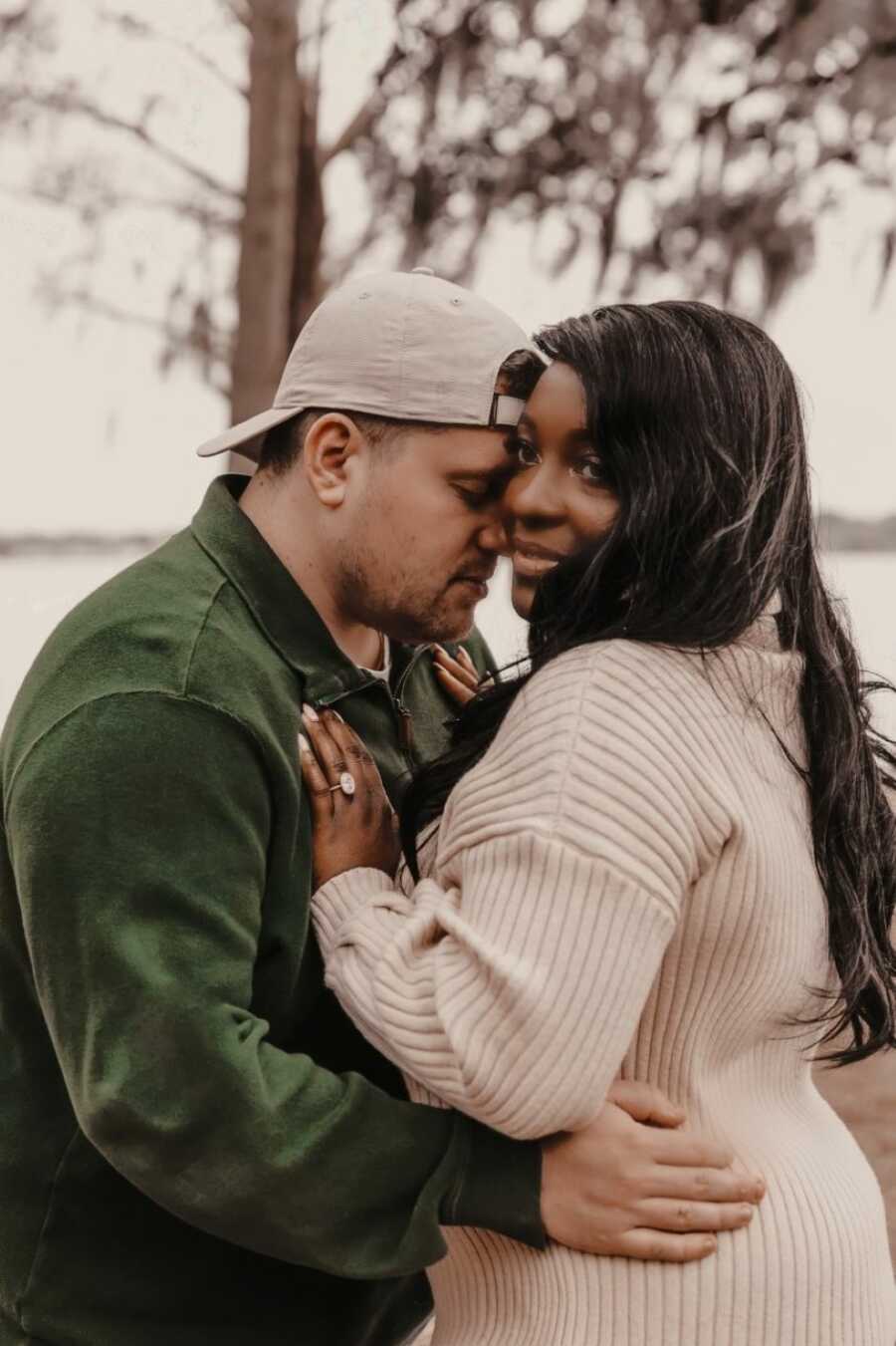 Newly engaged couple take intimate photo during their engagement photoshoot