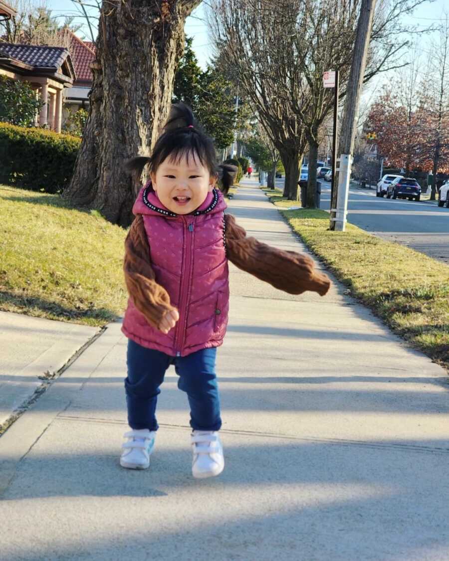 little girl walking towardsmom