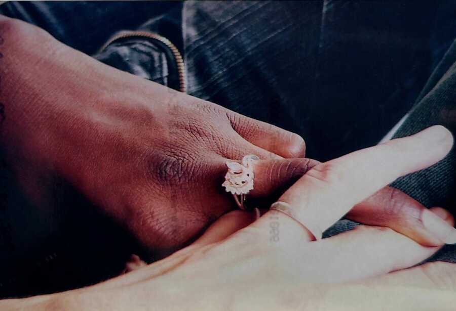 couple taking a picture of their rings
