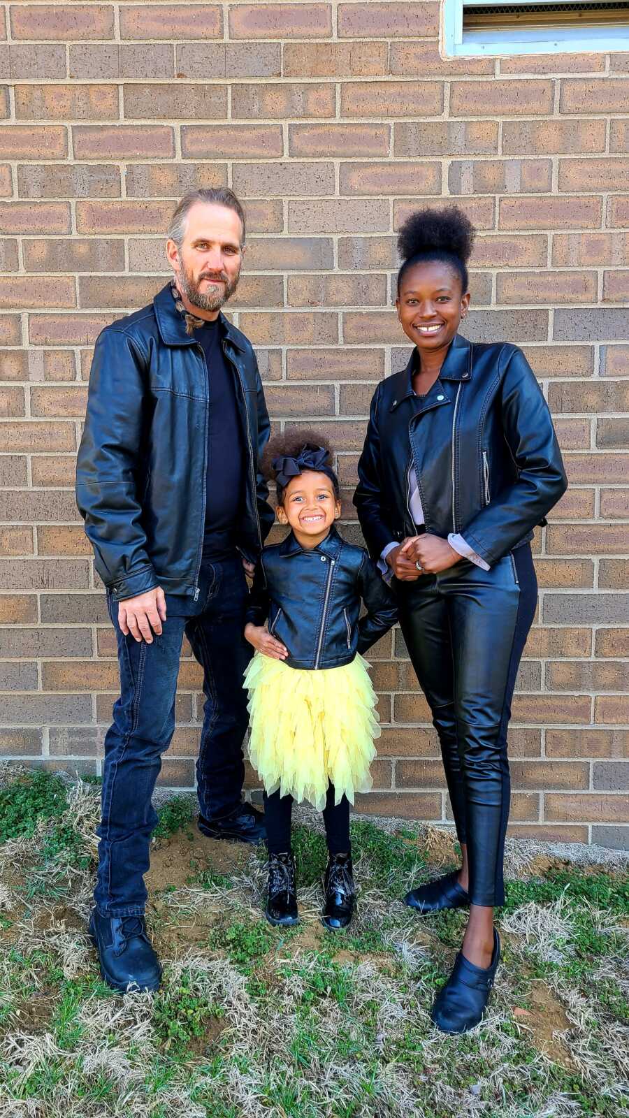 family in a photo in matching jackets