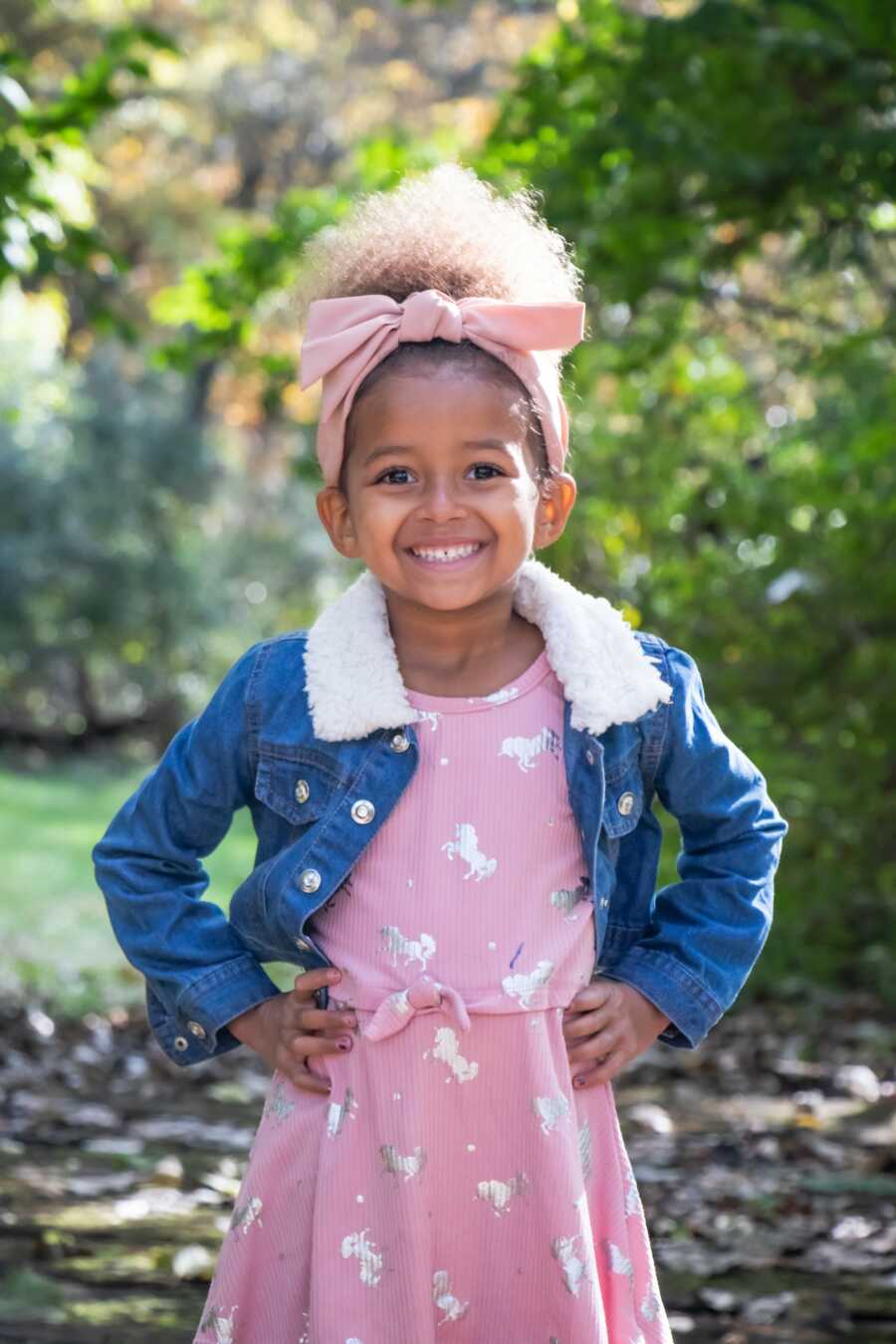 little girl in pink shirt and jean jacket