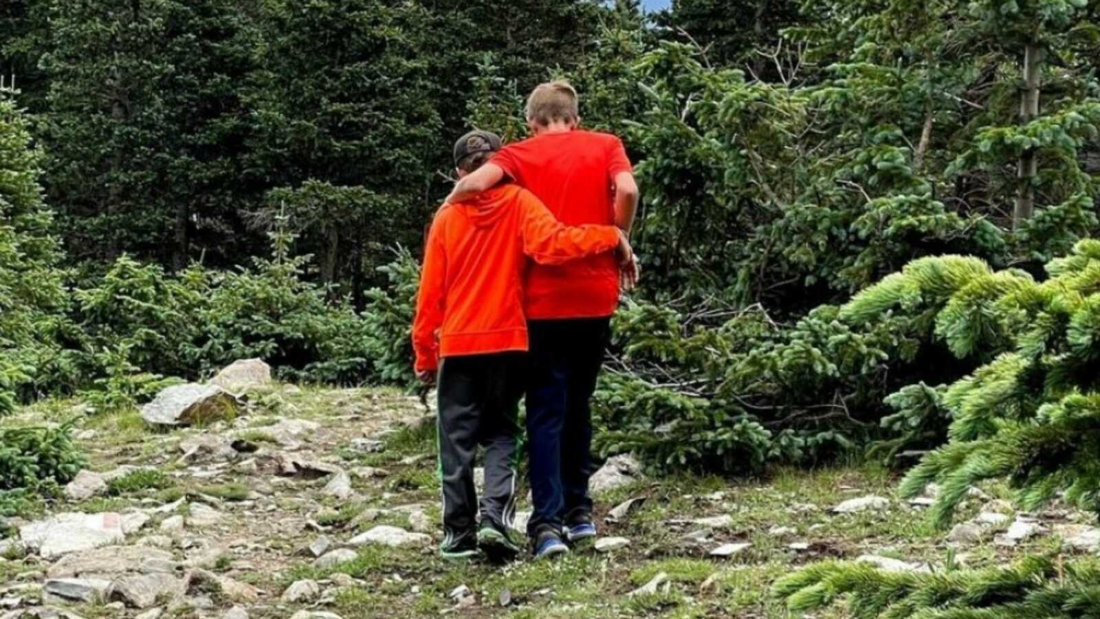 two brothers out in the forest hiking together
