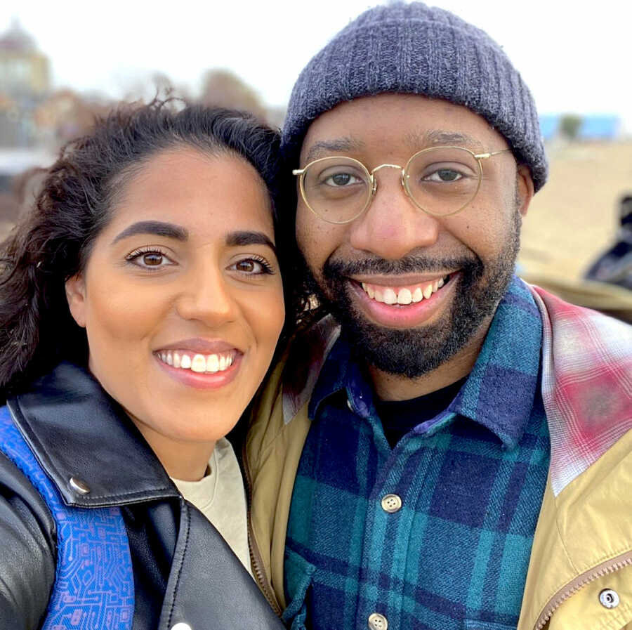 Black husband and Pakistani wife take a selfie, smiling softly