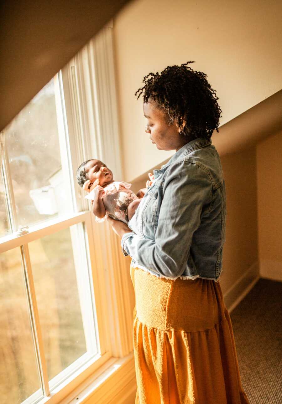 woman holding her baby smiling