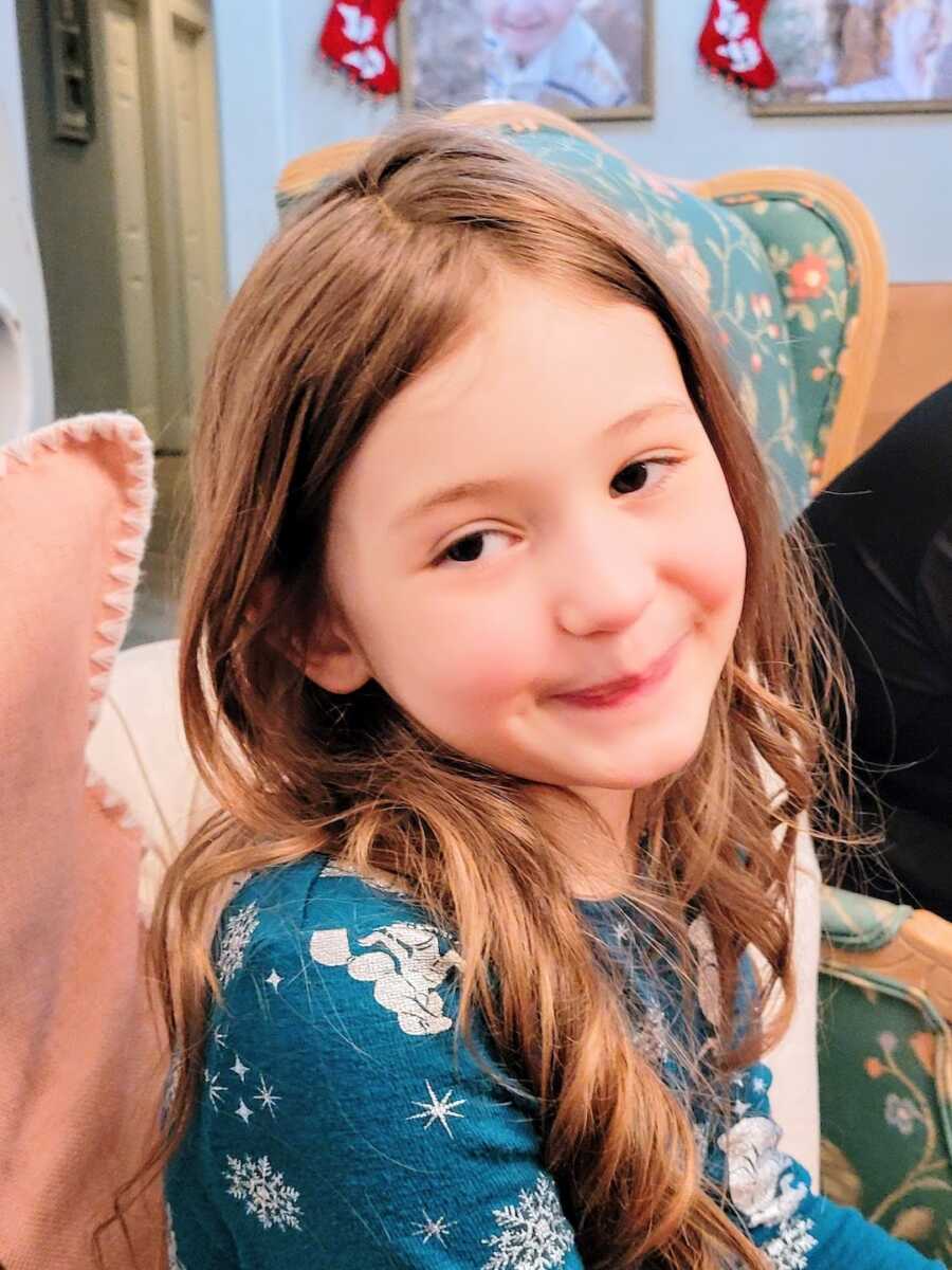 Daughter looks to camera with a slight smile on her face