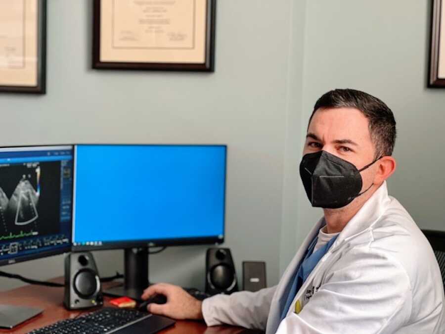 man at his desk during his cardiology fellowship