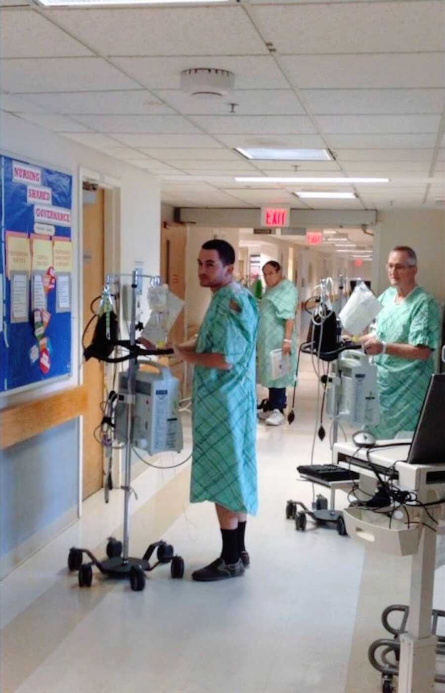 man stands in hospital wing during a hospital stay as he awaits a heart for transplant