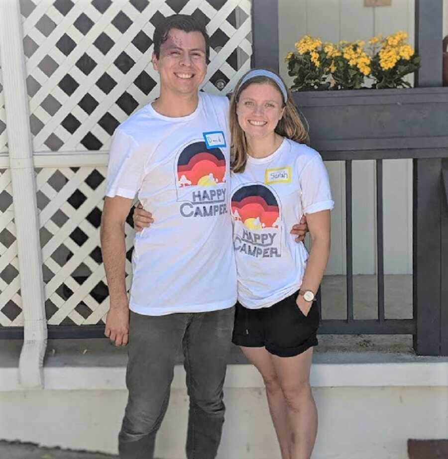 Couple wears happy camper shirts for volunteering as camp counselors for foster kids.