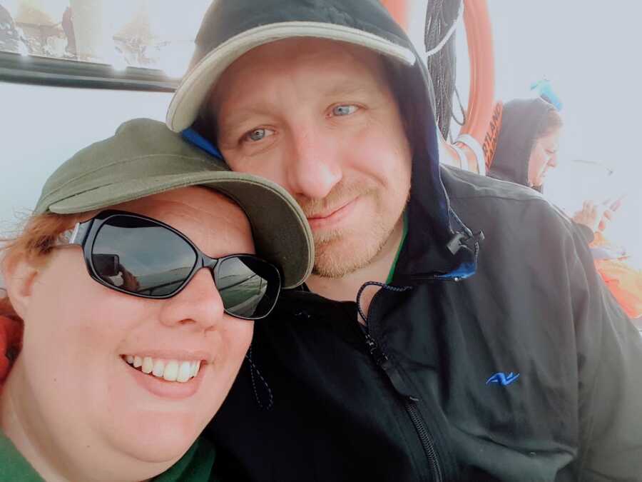 woman takes a selfie with her husband, both are smiling