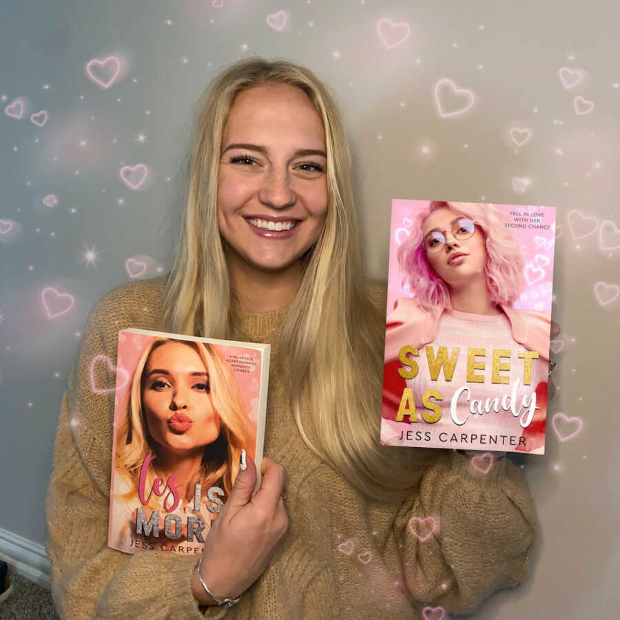 mother poses with her two published books she wrote after having two kids