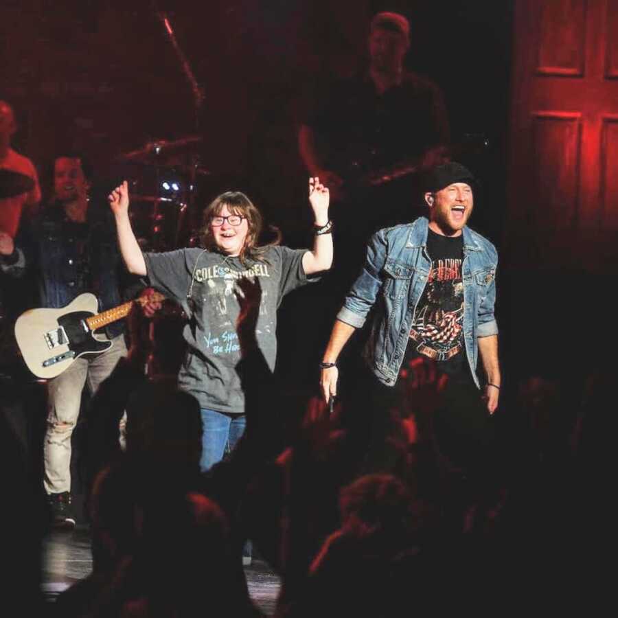 Cole Swindell invites excited fan on stage with him during her favorite song at a concert