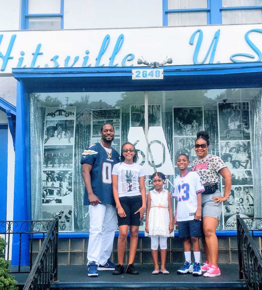 blended family stands in front of Hitsville U.S.A. sign, three children and their parents