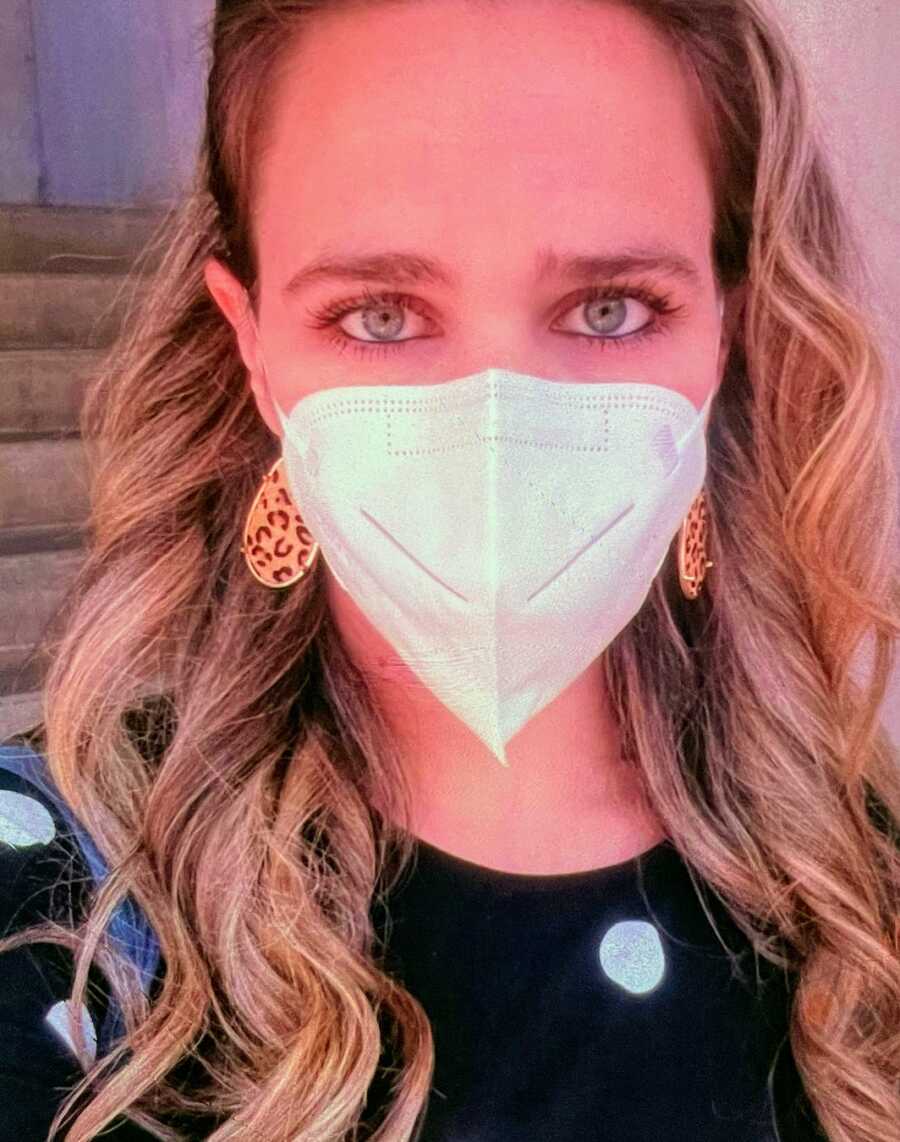 selfie of adopted daughter with protective face mask on waiting to visit her mother in hospice