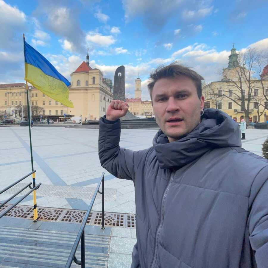Ukrainian man takes picture in historic area of Lviv.